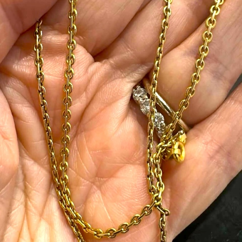 Gold Chain Necklace with unique chain pattern.